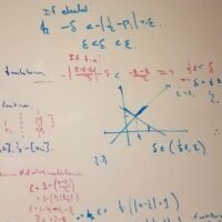many equations on whiteboard