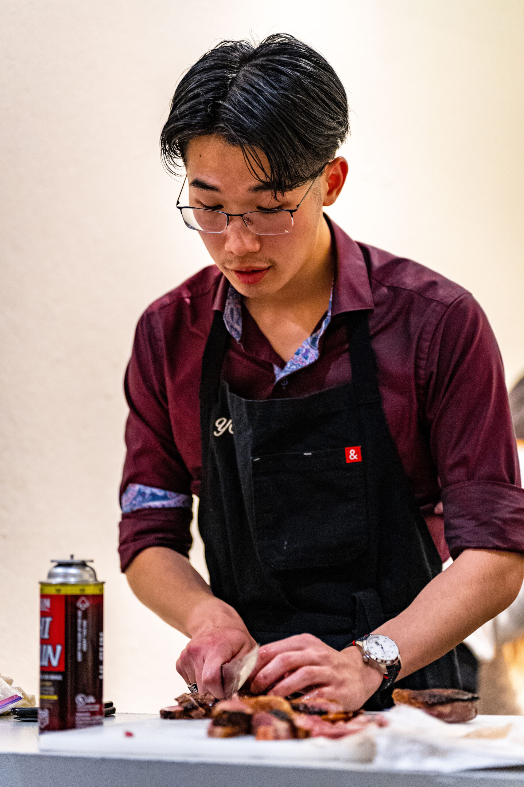 person slicing meat on table