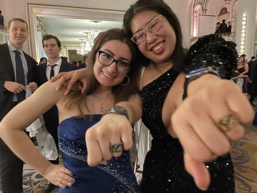 2 people posing with the class ring