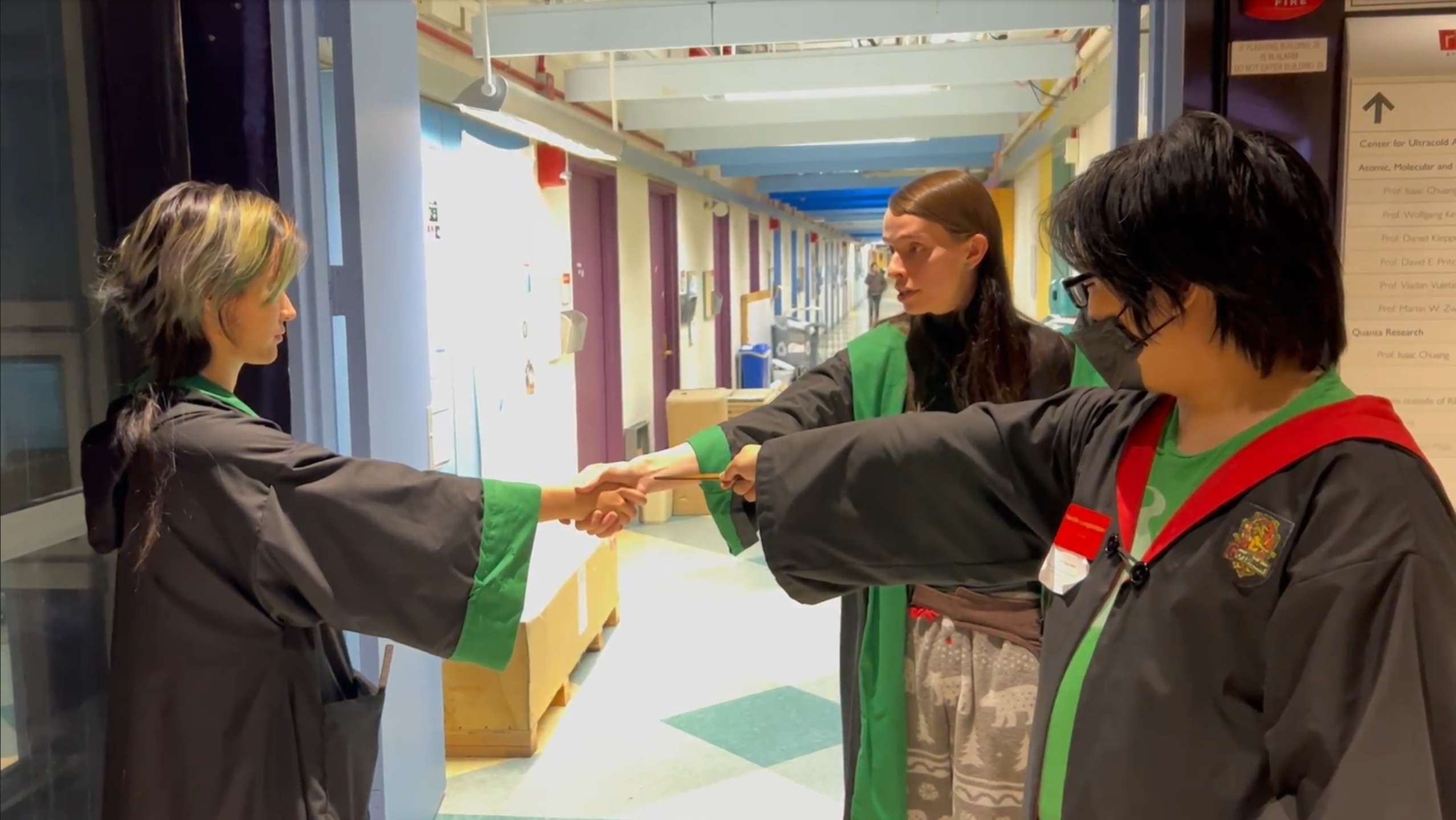 claude and millicent shaking hands, with neville pointing a wand