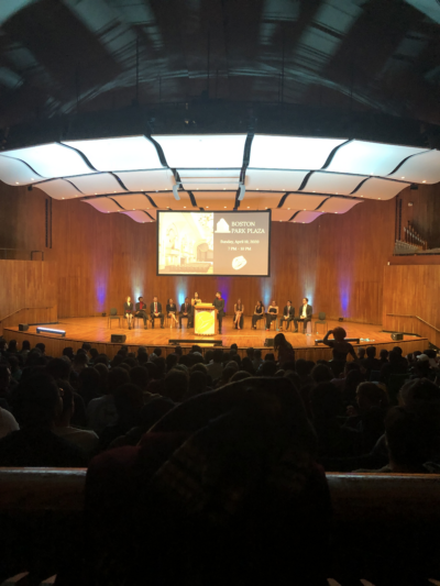 auditorium full of people, facing the stage