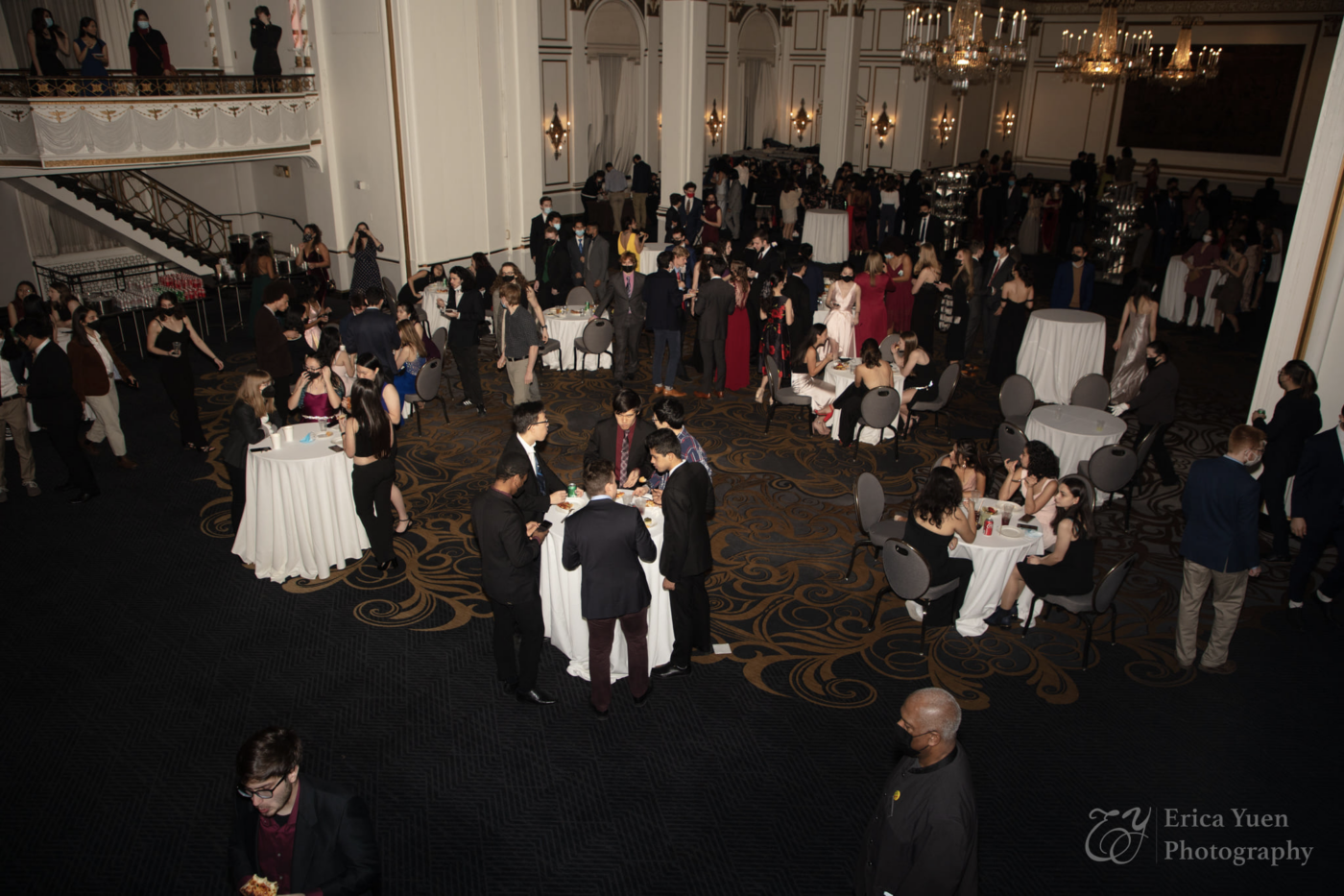 large room full of well-dressed people and tables